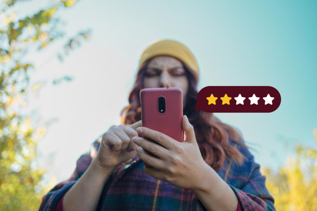 Woman reviewing rating on smartphone outdoors